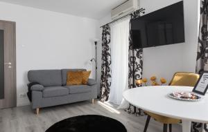 a living room with a couch and a table at Lion's Unirii Apartment in Bucharest