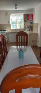 a kitchen with a table with a blue bowl on it at Hospedaje Venka Urubamba in Urubamba
