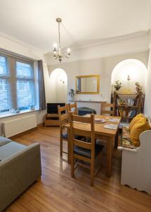 a dining room and living room with a table and chairs at Skipton at Six in Skipton
