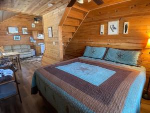 een slaapkamer met een bed in een houten kamer bij Walnut Canyon Cabins in Fredericksburg