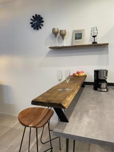 a wooden table with two wine glasses on it at Behagliches Haus Luisa in der Dorfmitte in Ippesheim