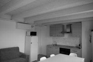 a kitchen with a table and a chair and a couch at Villa AMARE in Caorle