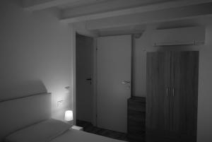 a bedroom with a bed and a dresser and a closet at Villa AMARE in Caorle