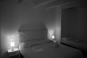 a black and white photo of a bed with two lamps at Villa AMARE in Caorle