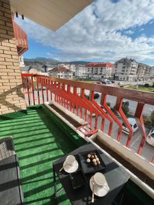 a balcony with a table and a view of a city at President Lux Apartment in Pale