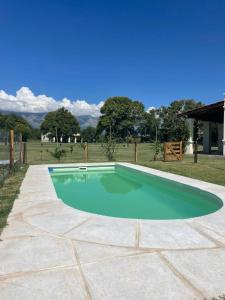 a swimming pool in the middle of a yard at La Catalina Suites de Campo in Nono