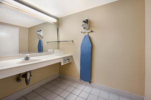 a bathroom with a sink and a mirror at Knights Inn College Station in College Station