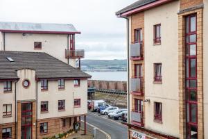 a view of a street between two buildings at Isla Retreat - Donnini Apartments in Ayr
