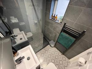 an overhead view of a bathroom with a toilet and a sink at Modern & retro two bedroom apartment in Barnsley in Barnsley