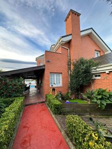 a brick house with a red carpet in front of it at !Chalet de lujo para vacaciones!... in Camargo