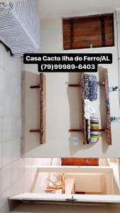 a bathroom with a sink and a mirror at Casa Cacto - Ilha do Ferro AL in Pão de Açúcar