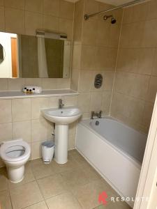 a bathroom with a sink and a toilet and a bath tub at New Renovated Arcadian Centre - One Bedroom - Balcony - Sofa Bed in Birmingham