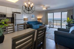 a kitchen and living room with a view of the ocean at Sea Mystique Resort in Myrtle Beach