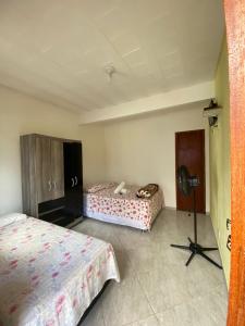 a room with two beds and a camera in it at Pousada Vale do Luar in Sana