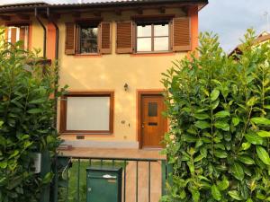 a house with a fence in front of it at Villa Elisa in Saluzzo