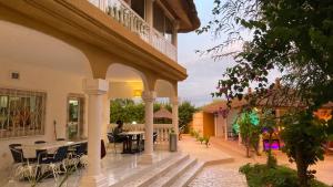 an outdoor patio with tables and chairs in a building at Villa Kounzo in Ndangane