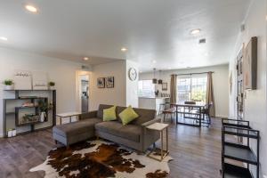a living room with a couch and a kitchen at Marbella Lane - Neat and Cozy Modern Home in East Palo Alto