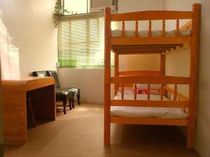 a room with two bunk beds and a desk at Jin Lon Hotel in Taitung City