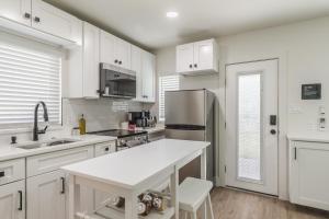 a white kitchen with a sink and a refrigerator at Luxury Tiny Home 2 Miles from Downtown Orlando in Orlando