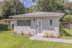 a small house in a yard with green grass at Luxury Tiny Home 2 Miles from Downtown Orlando in Orlando