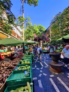 a market with fruits and vegetables on a street at Funchal Old Town Studios - Historic Atlantic View in Funchal