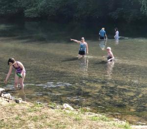 a group of people playing in the water at Astounding River View in Copperhill