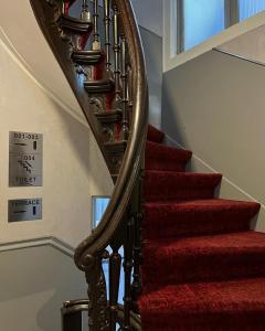 a stairway with red carpeting and a red rug at Facade Hotel Amsterdam in Amsterdam +58 photos