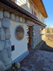 a stone building with a sign on the side of it at Willa Hajnówka in Zakopane