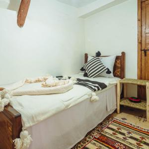 a bed sitting in a room with at Atlas Kasbah Lodge in Imlil