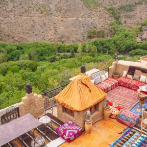 a living room with a couch and a view of a mountain at Atlas Kasbah Lodge in Imlil