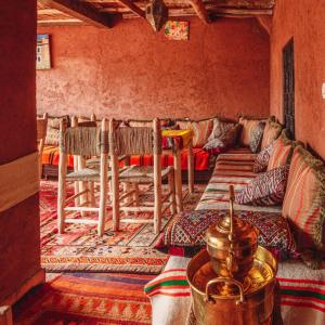 a living room with a couch and some chairs at Atlas Kasbah Lodge in Imlil