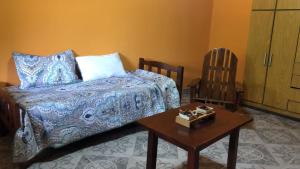 a bedroom with a bed and a table and a chair at Cabaña Emilia in San Javier