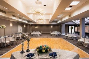 a banquet hall with tables and chairs and a chandelier at Crowne Plaza Edison, an IHG Hotel in Edison