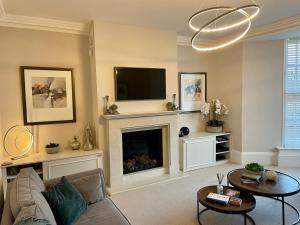 a living room with a couch and a fireplace at Edge Mere Apartment, Bowness-on-Windermere in Bowness-on-Windermere