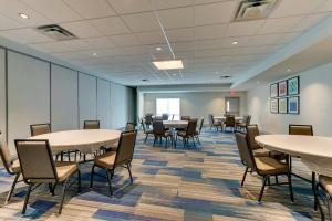 a room with tables and chairs in a building at Holiday Inn Express & Suites - Dawsonville, an IHG Hotel in Dawsonville