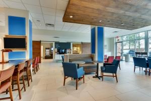 a dining room with chairs and a table in a building at Holiday Inn Express & Suites - Dawsonville by IHG in Dawsonville