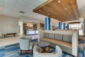 a waiting area in a hospital with chairs and a bench at Holiday Inn Express & Suites - Dawsonville, an IHG Hotel in Dawsonville