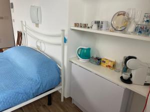 a room with a bed and a shelf with items at LASOMMO 1 in Riomaggiore