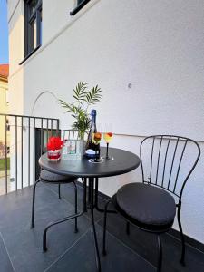 a table with two chairs and two glasses of wine at Villa Riverside in Ljubljana