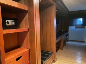 a room with wooden cabinets and a tv in a room at Hotel Contadero Suites y Villas in Mexico City