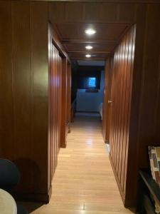 a hallway with wood paneling and a room with a bed at Hotel Contadero Suites y Villas in Mexico City