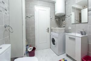 a white bathroom with a washing machine in it at Gorgeous Los Diamantes Home in Los Cristianos