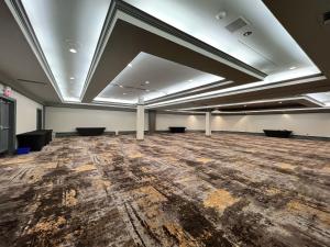 an empty room with a wooden floor and a ceiling at Holiday Inn Toronto Airport East, an IHG Hotel in Toronto