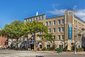 a building on the corner of a street at Best Western Gregory Hotel in Brooklyn