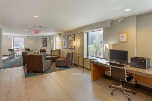 a waiting room with chairs and a desk with a computer at Best Western Gregory Hotel in Brooklyn