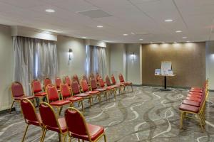 a conference room with red chairs and a podium at Best Western Gregory Hotel in Brooklyn