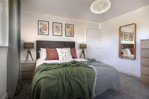 a bedroom with a large bed and a mirror at Scar View - Getaway for Two in Underbarrow