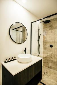 a bathroom with a sink and a shower at Warners at the Bay in Warners Bay