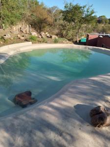a pool of water with two rocks in it at Camino al Cuadrado in Río Ceballos