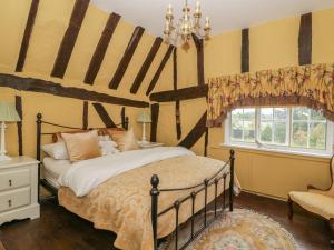 a bedroom with a bed and a window at Waveney Cottage in Diss